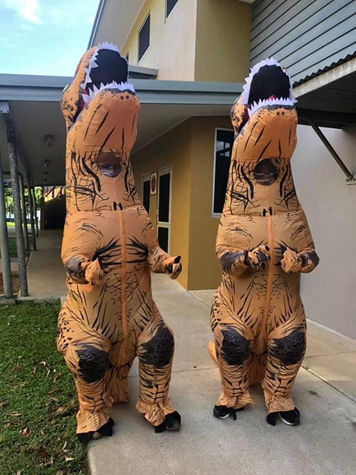 TRex costumes welcoming people