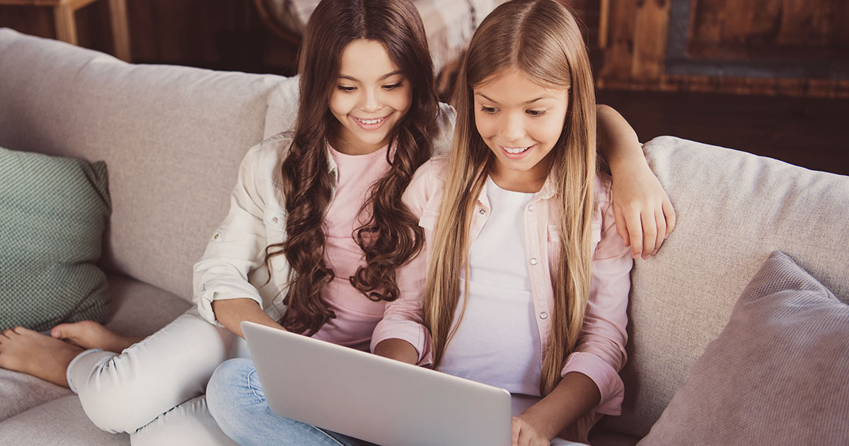 2 girls online learning at home with their laptop