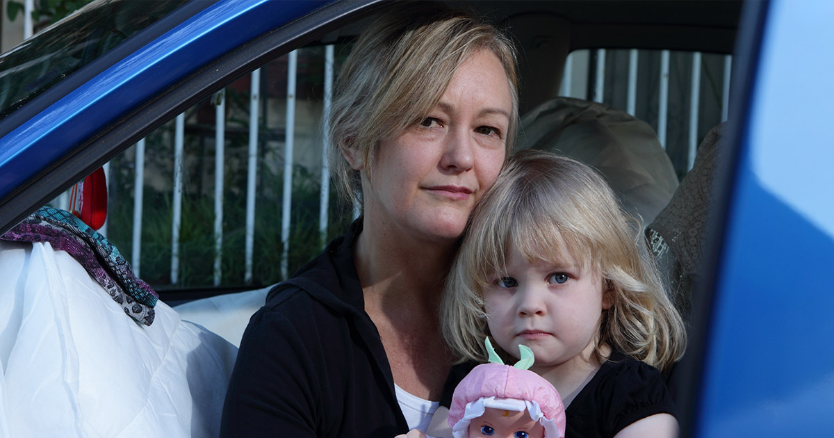 A mother with her daughter living in a car