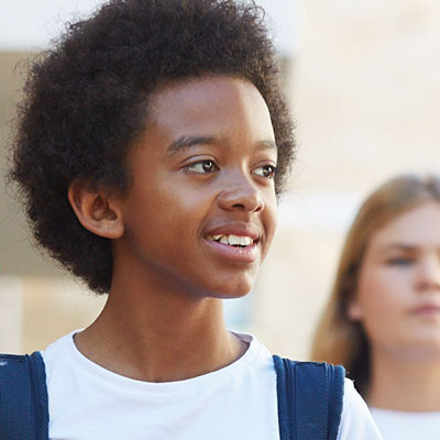 Two boys walking along a street