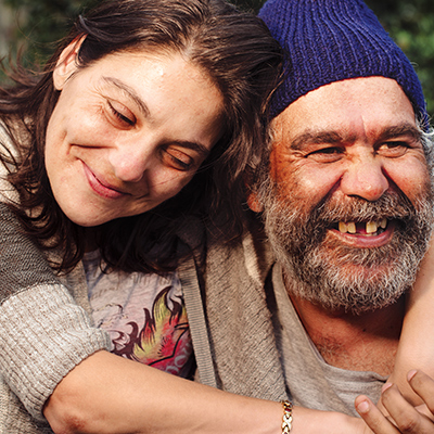 Two people embracing on a park bench