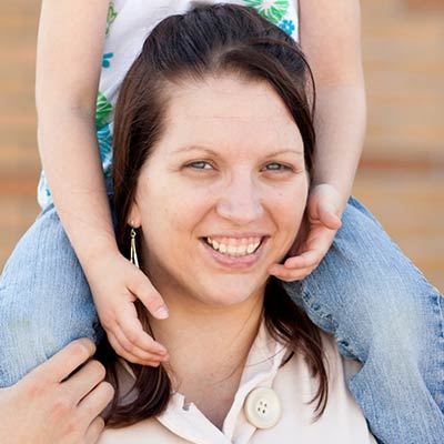 Mother with child on her shoulders