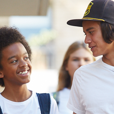 Two young boys walking along a speech