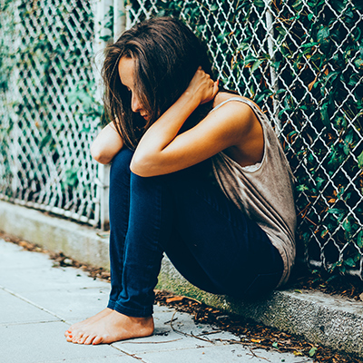 Young sad girl with her head in her hands