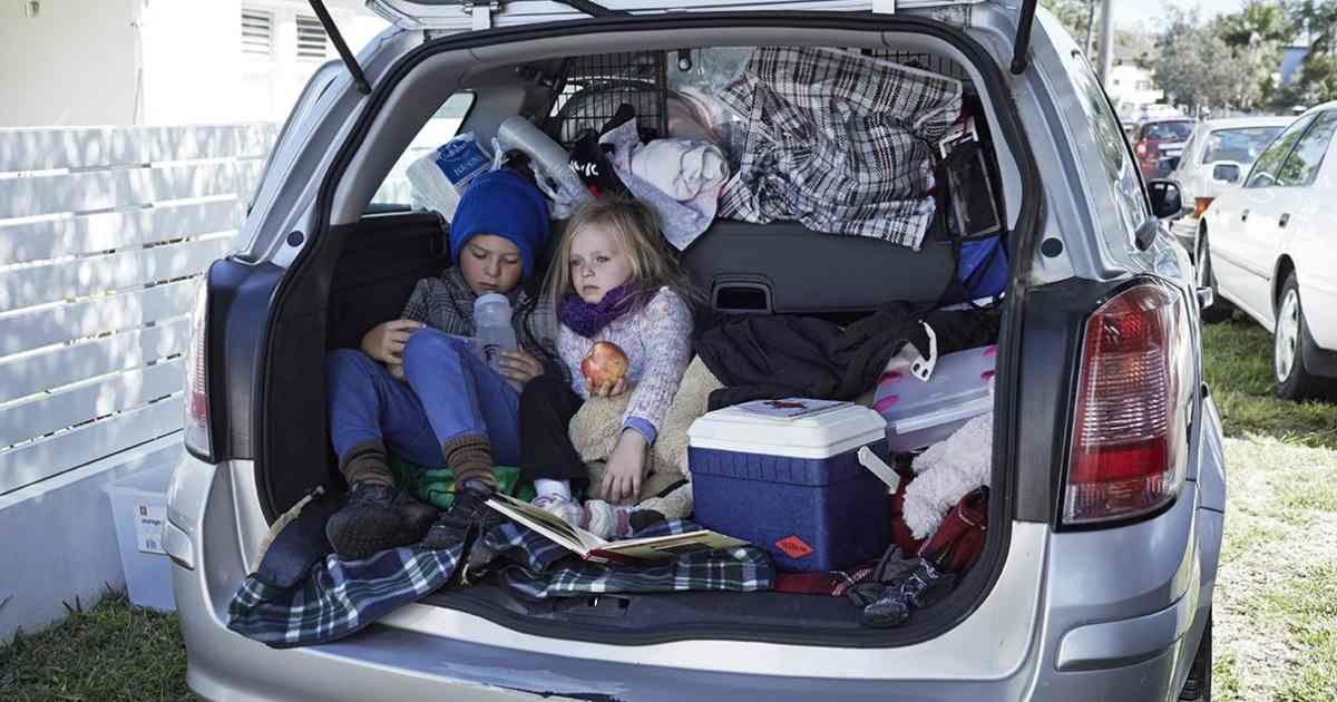 Children sitting in the back of their makeshift home. 