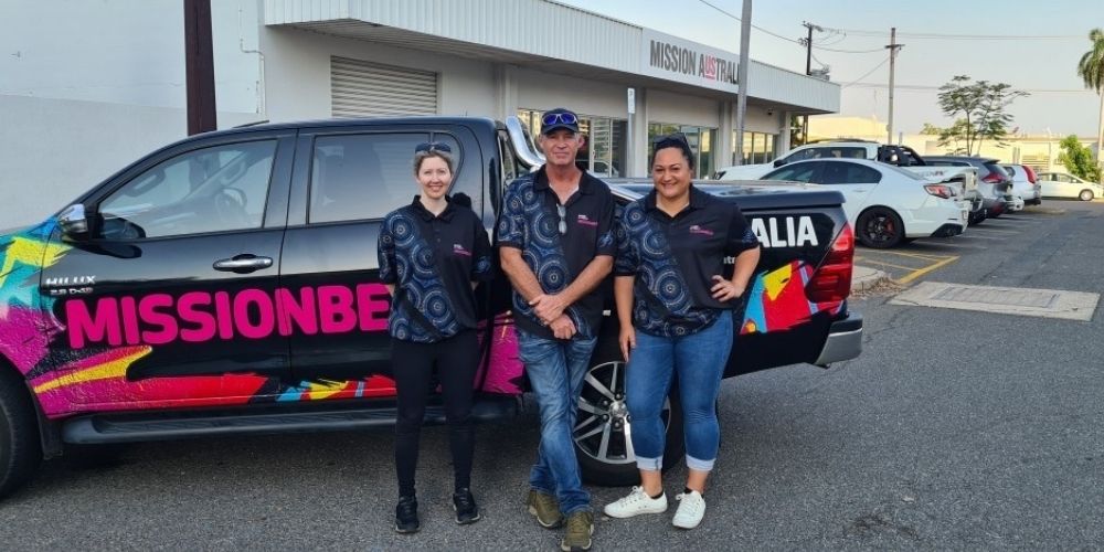 Missionbeat team from NT standing and smiling next to the Missionbeat ute. 