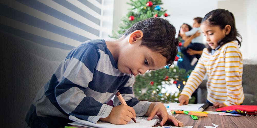 children together with their mother around the Christmas tree