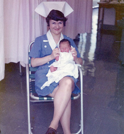 Lois sitting with a baby