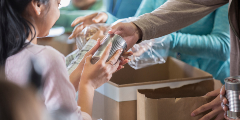 worker provides aid with food after floods