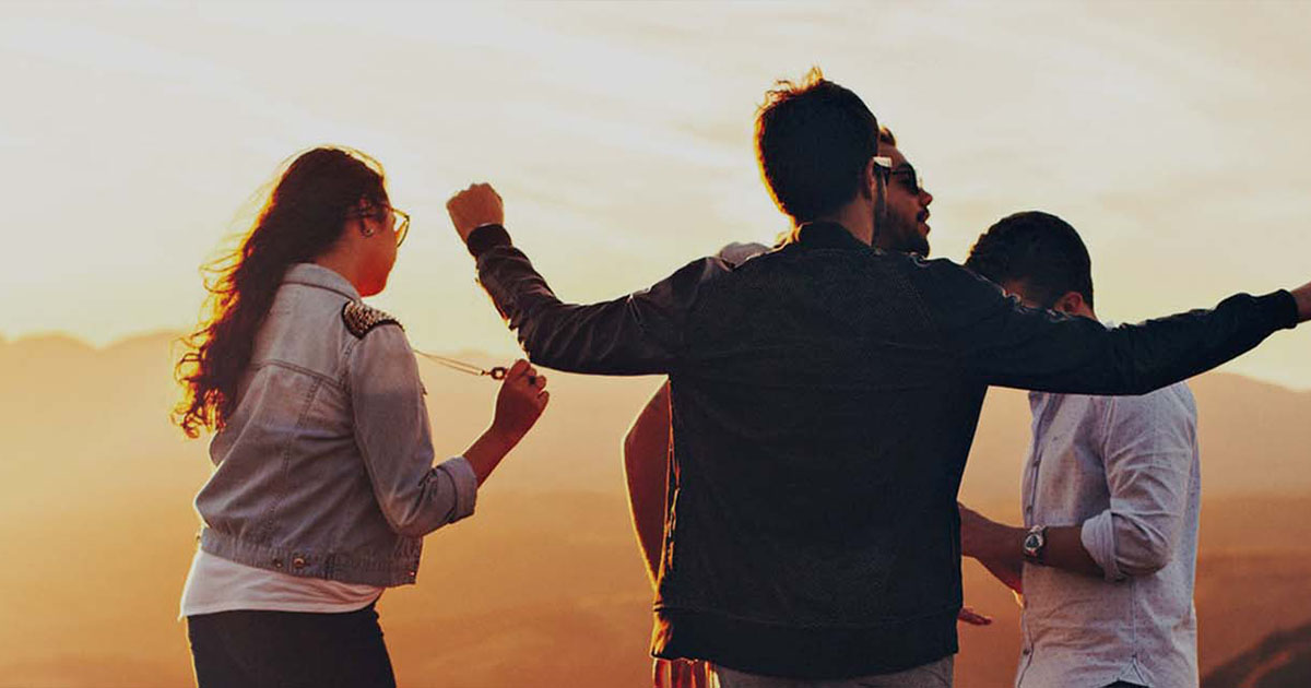 Four young people hanging out outdoors