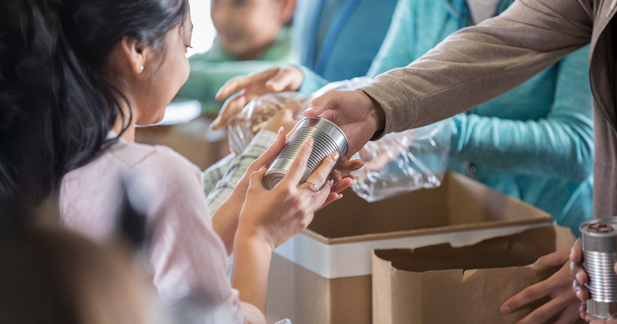 a kid receive a help donation  from charity