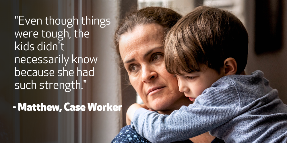 A brown haired lady, holds her son and looks out with window with a concerned look on her face. Text on image reads “Even though things were tough, the kids didn't necessarily know because she had such strength.”