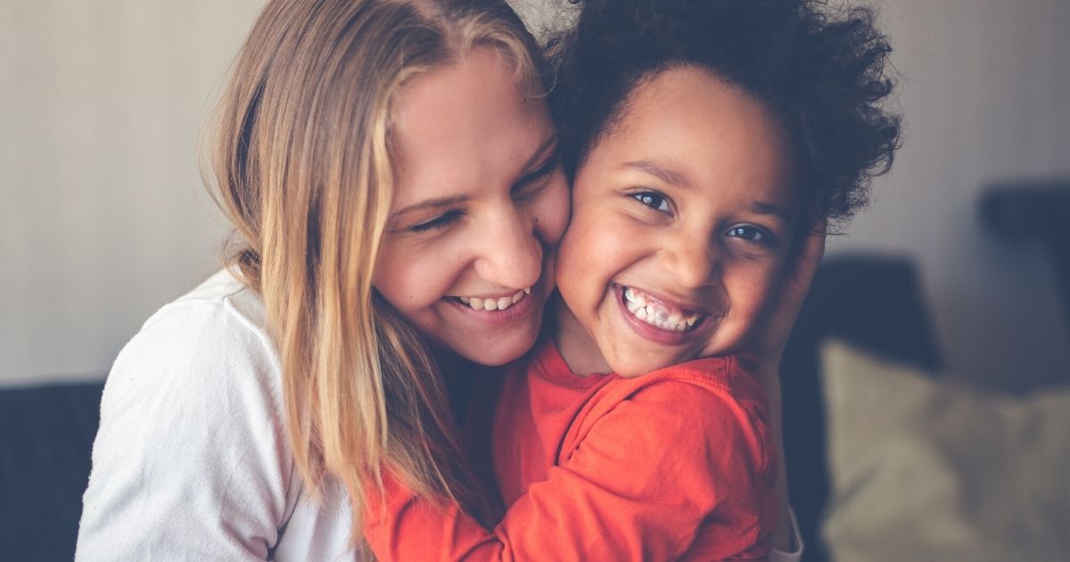 Tessa is hugged by her young daughter.