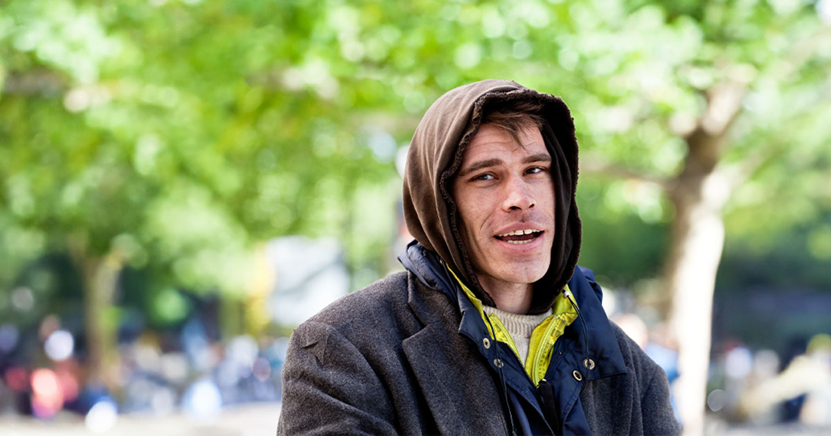 homeless man looking hopeful