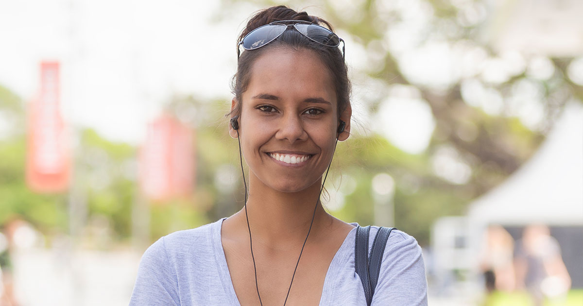 oung woman smiling and looking toward the camera.