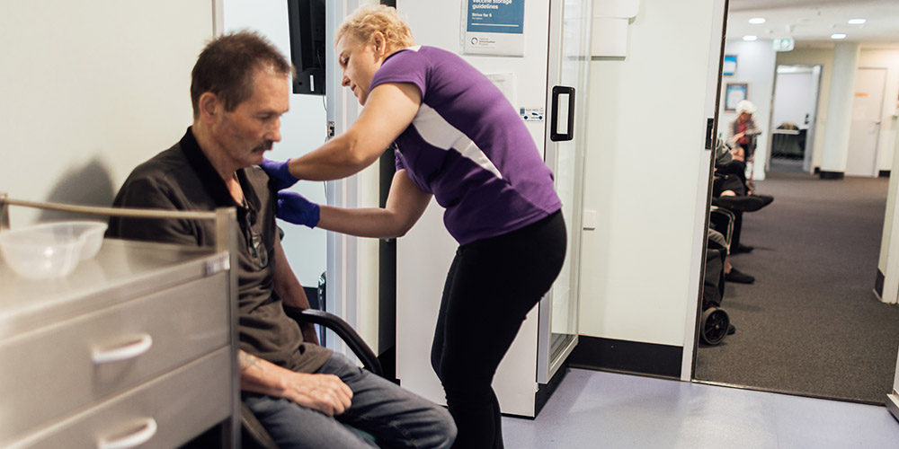 Resident of Charles Chambers Court is being vaccinated