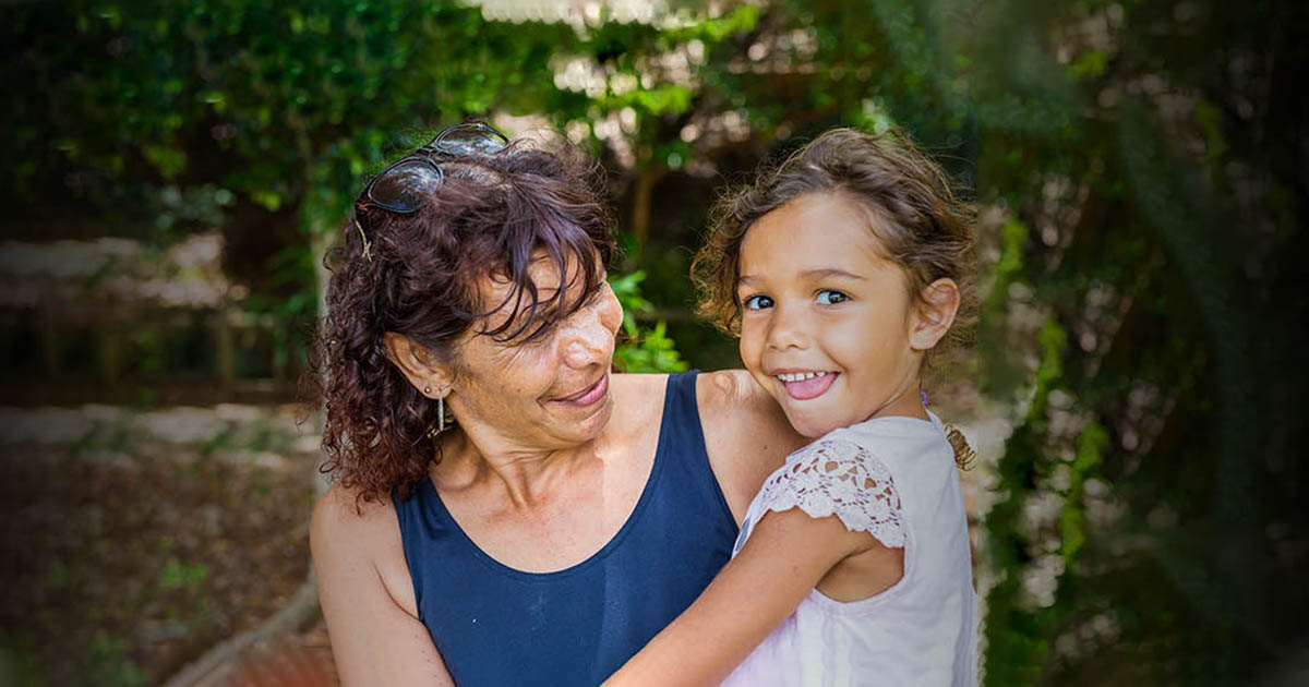 A mother with her daughter looking happy