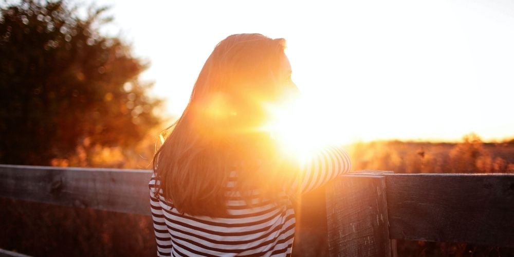 Young lady looking at sunset 