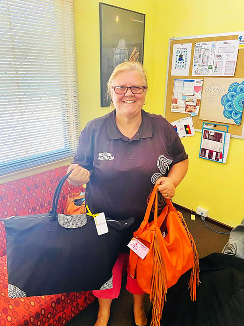 Mission Australia worker with support bags