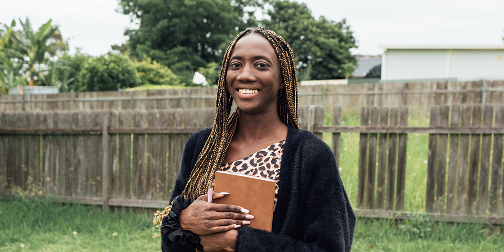 A confident Saran, smiles toward the camera