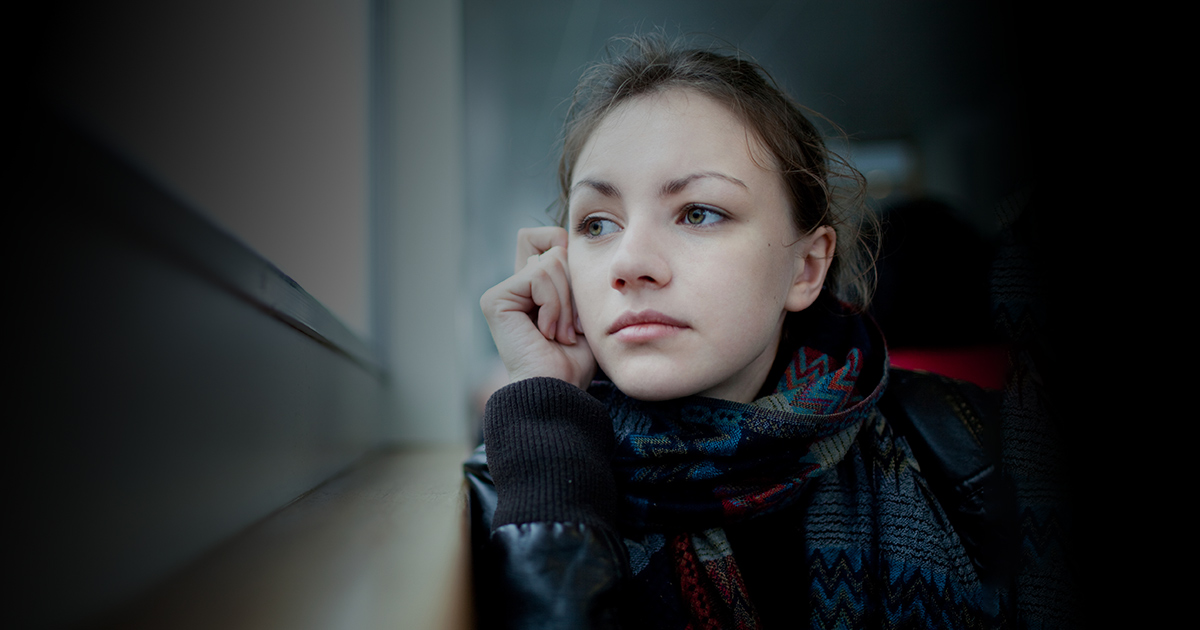 Young girl looking out the window