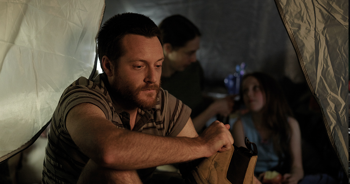 Family sitting in a tent