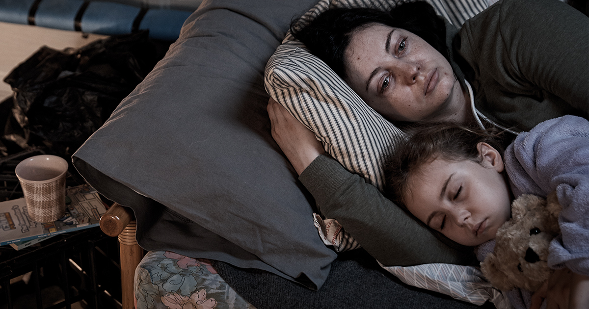 Homeless woman with her child living in a garage