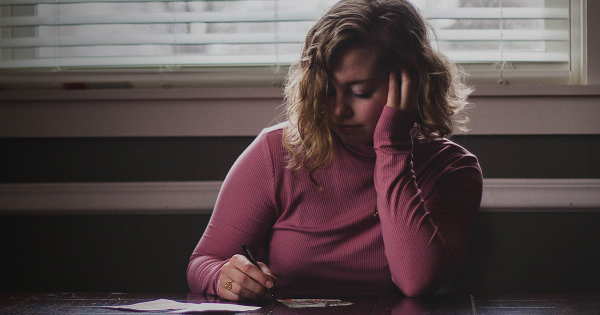 Woman sitting at a desk looking upset