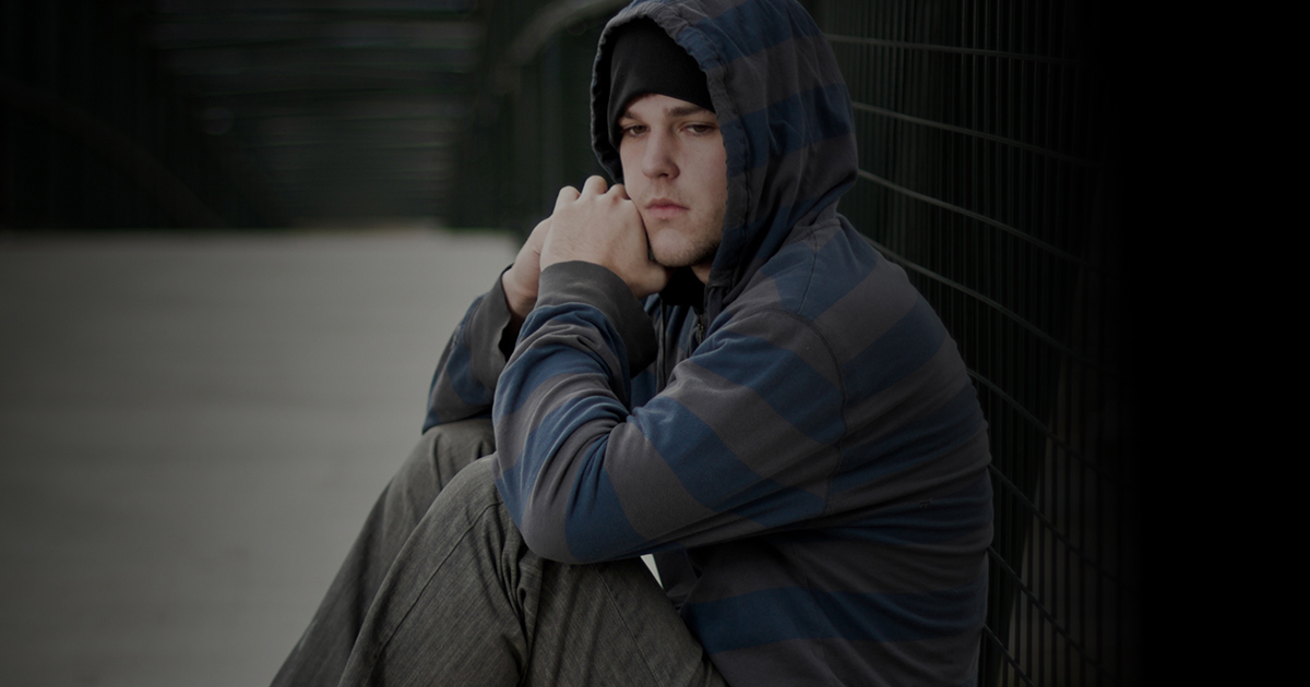 Young boy sitting on the ground