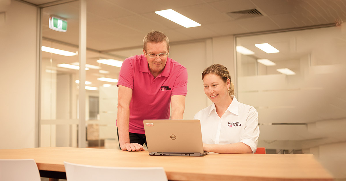 Mission Australia staff using the computer