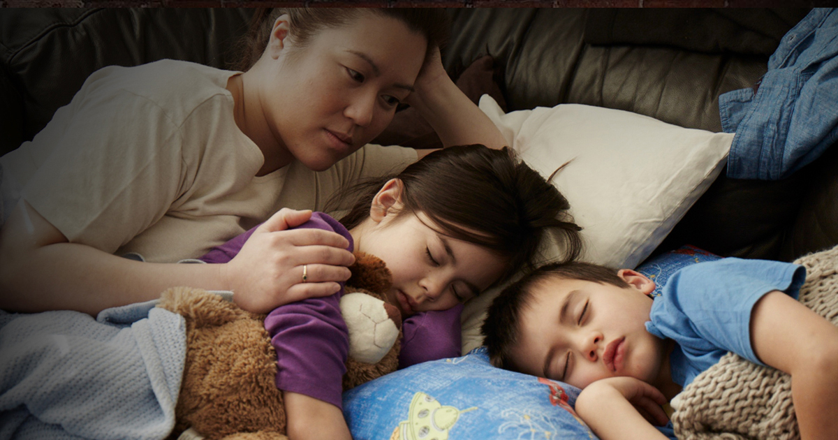 Family sleeping on a couch