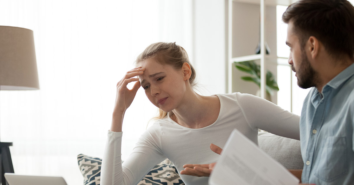 Wife arguing with husband over document paper