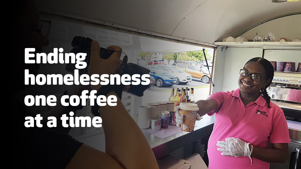 Women holding coffee towards a camera and smiling.  