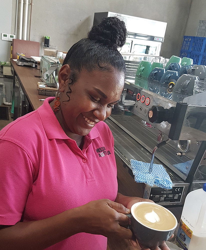 Women holding coffee and smiling