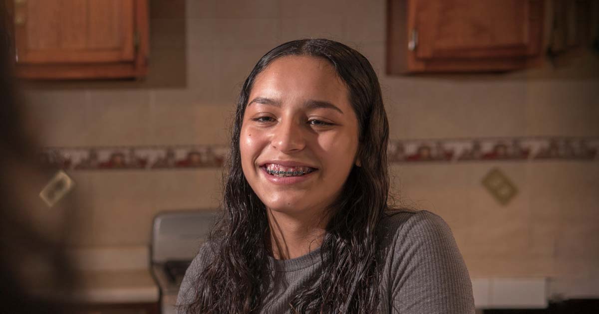 Teenage girl with braces happy and smiling at camera