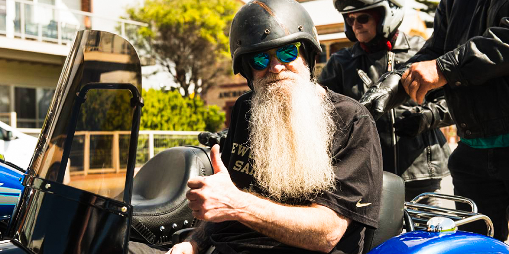 Terry gives a thumbs up from the side car of the Harley Davidson.