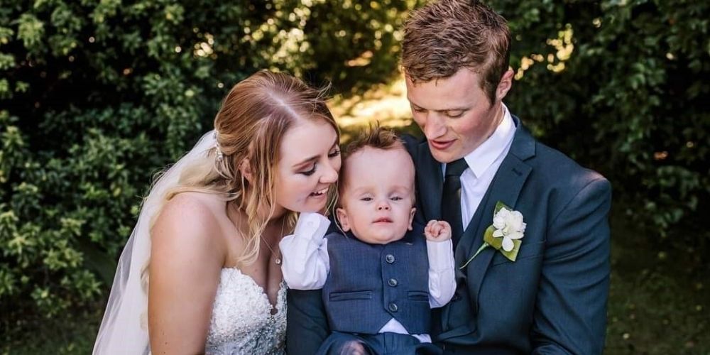 Maddison on her wedding day holding Lawson.