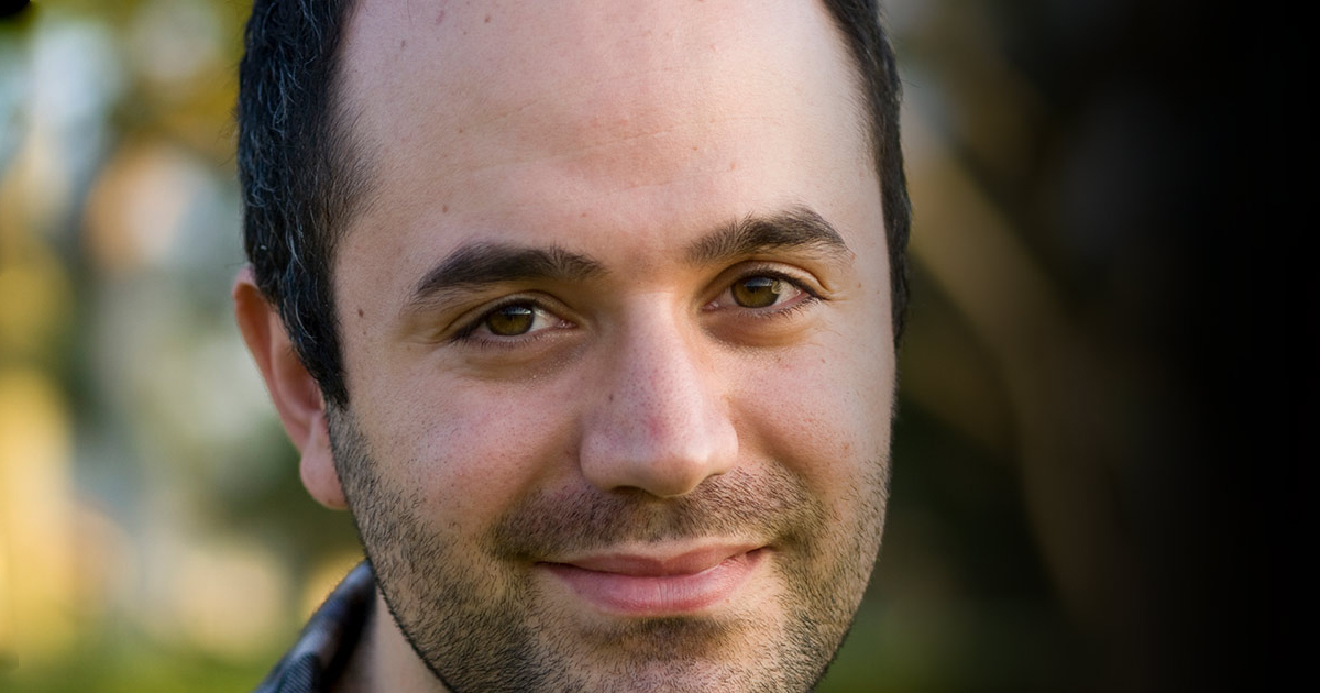 A man looking into the camera in the park