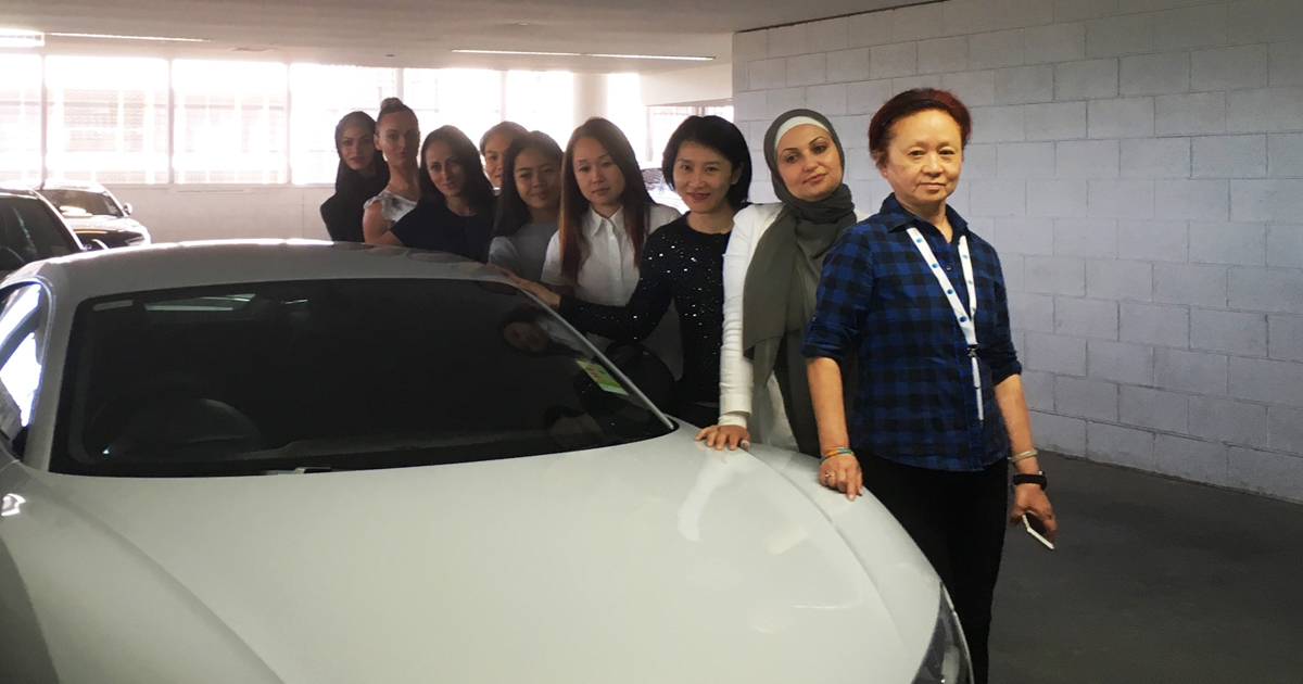 Women standing in front of an Audi