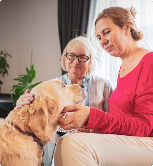 Janelle and her mum patting their dog