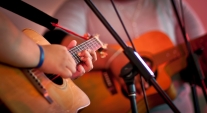 People playing a guitar on stage