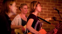 A band playing in front of a crowd at CYI