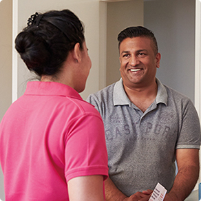 Man smiling and talking to a Mission Australia worker