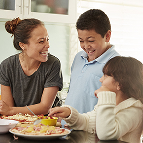 A woman laughing and talking to her children