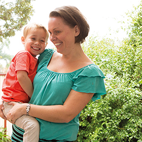 A woman holding her son in her arms