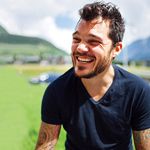 A man laughing outdoors