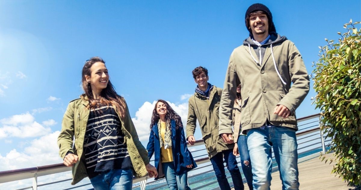 Four people walking and talking. 